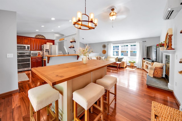20 Cimmarron Dr, Nashua, NH 03062 - dining room featuring a wall mounted air conditioner, lofted ceiling, a chandelier, dark wood-style flooring, and recessed lighting