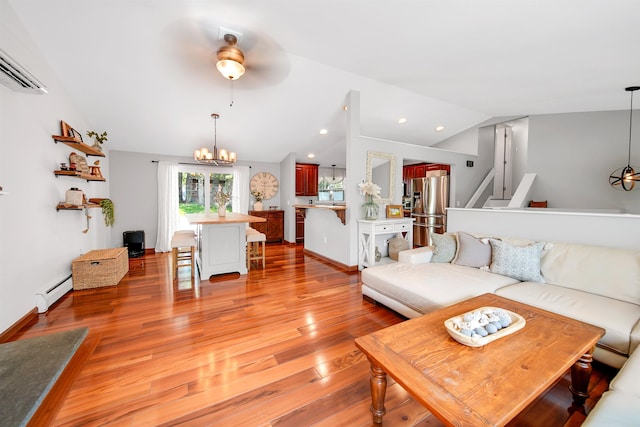 20 Cimmarron Dr, Nashua, NH 03062 - living area with vaulted ceiling, a wall mounted AC, light wood-type flooring, a chandelier, and a baseboard radiator
