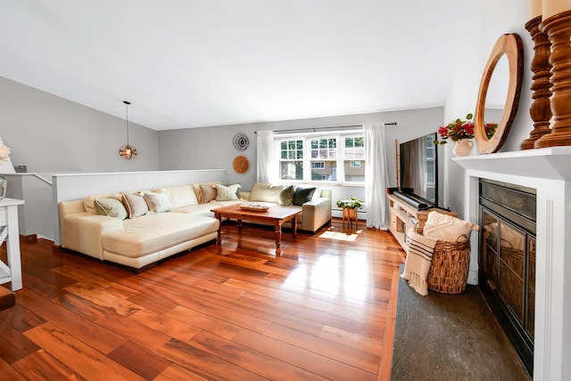 20 Cimmarron Dr, Nashua, NH 03062 - living area featuring a fireplace, hardwood / wood-style flooring, a baseboard radiator, and vaulted ceiling