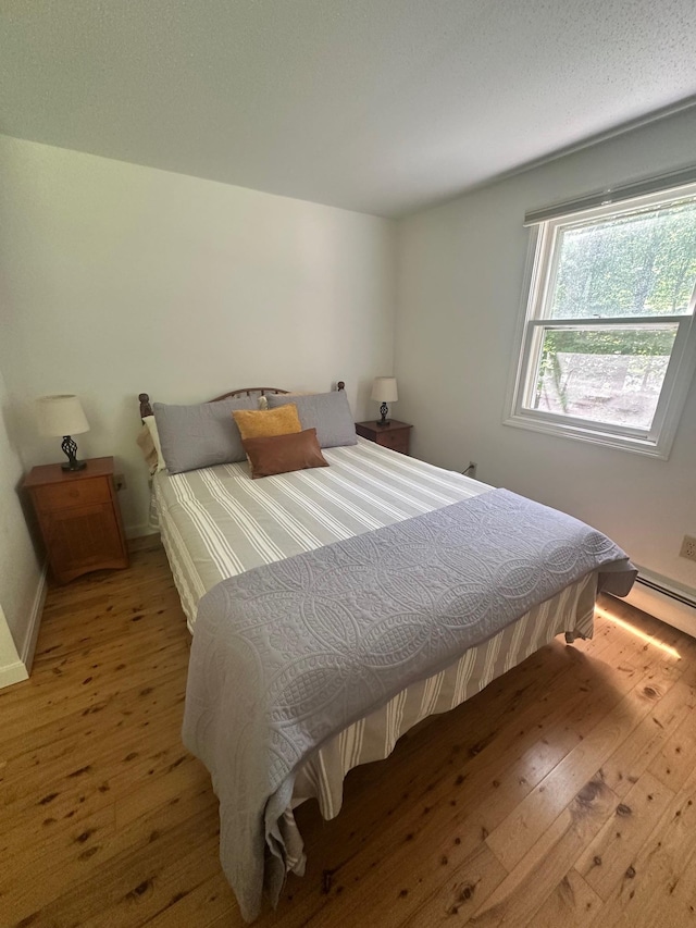 144 Windermere Rd, Moultonborough, NH 03254 - bedroom featuring light wood-style floors and a baseboard heating unit