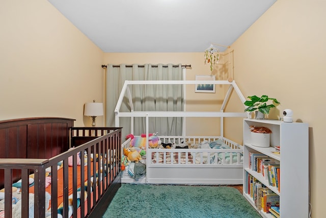 317 Old Concord Tpke Unit 1, Barrington, NH 03825 - bedroom featuring wood finished floors and a crib