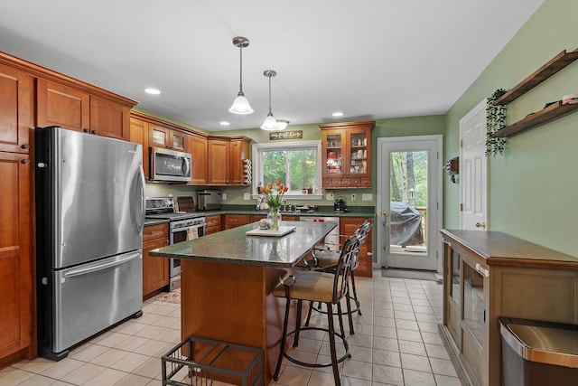 317 Old Concord Tpke Unit 1, Barrington, NH 03825 - kitchen featuring stainless steel appliances, recessed lighting, a kitchen breakfast bar, light tile patterned floors, and decorative light fixtures