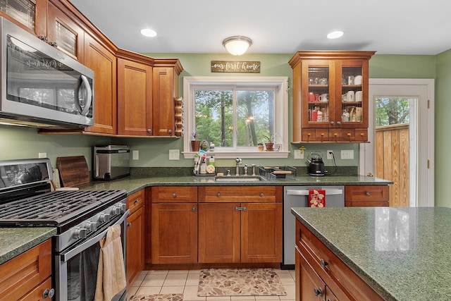 317 Old Concord Tpke Unit 1, Barrington, NH 03825 - kitchen featuring stainless steel appliances, light tile patterned flooring, plenty of natural light, brown cabinets, and recessed lighting