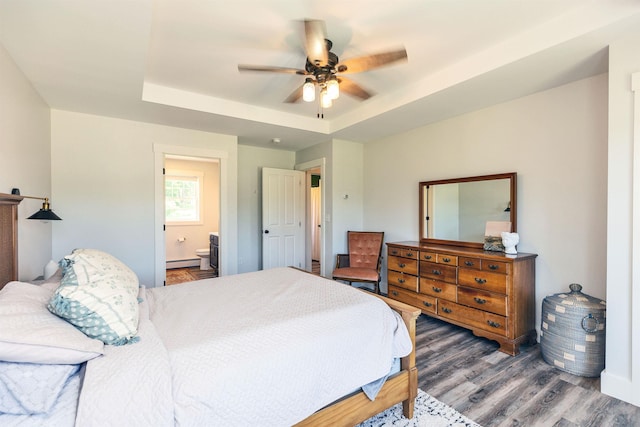 39 Windy Fields Ln, Jaffrey, NH 03452 - bedroom with a raised ceiling, a baseboard radiator, wood finished floors, connected bathroom, and a ceiling fan