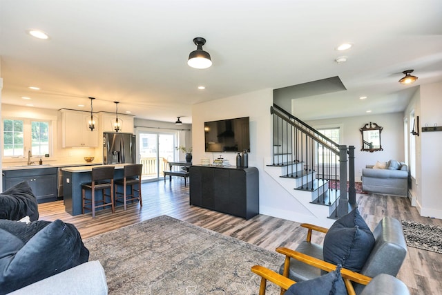 39 Windy Fields Ln, Jaffrey, NH 03452 - living room with healthy amount of natural light, wood finished floors, recessed lighting, and stairs
