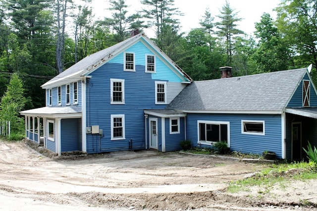 130 Shedd Rd, Hillsborough, NH 03244 - rear view of house with a chimney, view of wooded area, and a shingled roof