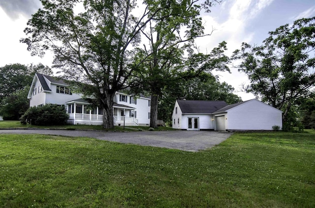 153 N Rd, Brentwood, NH 03833 - view of front facade with driveway, a garage, a front yard, and covered porch