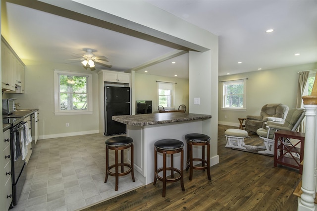 153 N Rd, Brentwood, NH 03833 - kitchen with black appliances, healthy amount of natural light, a breakfast bar area, and recessed lighting
