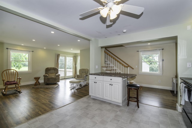 153 N Rd, Brentwood, NH 03833 - kitchen with a kitchen breakfast bar, healthy amount of natural light, white cabinets, electric range, and recessed lighting