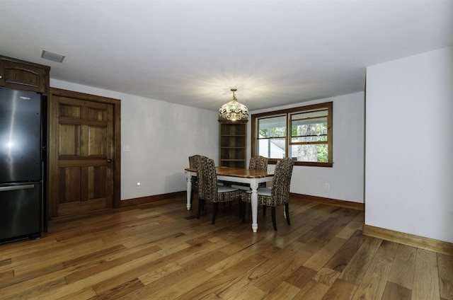153 N Rd, Brentwood, NH 03833 - dining room featuring light wood-style flooring and a chandelier