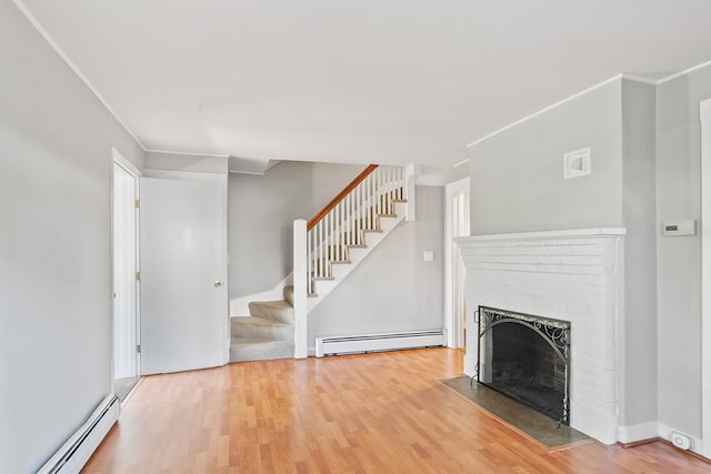 24B Grand Ave, Nashua, NH 03060 - unfurnished living room featuring a baseboard radiator, a fireplace, wood finished floors, and crown molding
