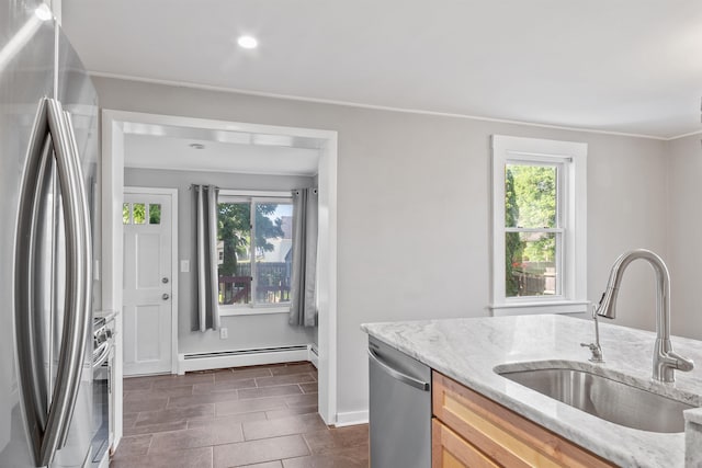 24B Grand Ave, Nashua, NH 03060 - kitchen with appliances with stainless steel finishes, a baseboard heating unit, healthy amount of natural light, light stone countertops, and recessed lighting