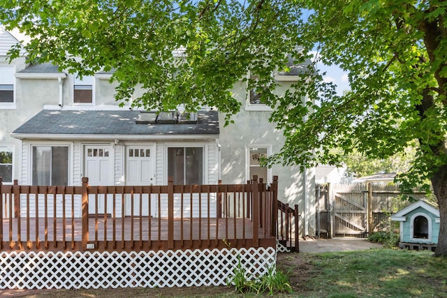 24B Grand Ave, Nashua, NH 03060 - rear view of house with a wooden deck and stucco siding