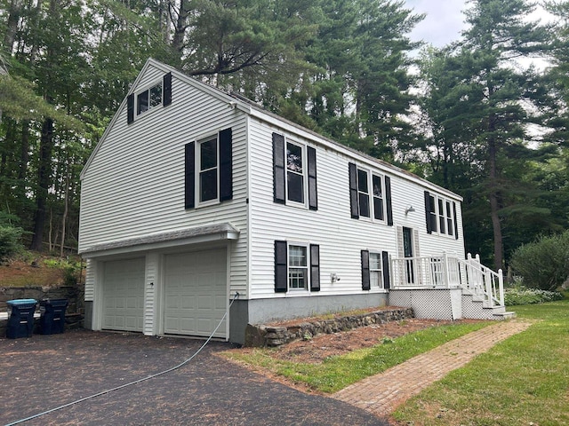 32 Muddy Pond Rd, Kensington, NH 03833 - view of front of home featuring a garage, driveway, and view of wooded area