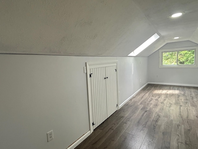 32 Muddy Pond Rd, Kensington, NH 03833 - additional living space featuring a skylight, lofted ceiling, dark wood-style floors, a textured ceiling, and recessed lighting