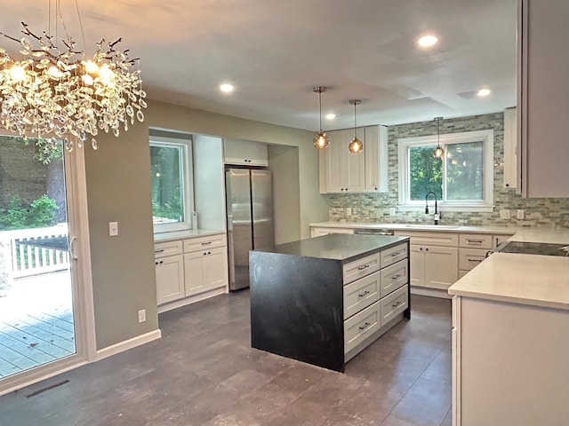 32 Muddy Pond Rd, Kensington, NH 03833 - kitchen featuring freestanding refrigerator, tasteful backsplash, a center island, decorative light fixtures, and recessed lighting