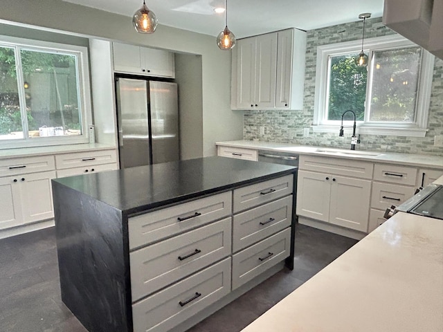 32 Muddy Pond Rd, Kensington, NH 03833 - kitchen with freestanding refrigerator, decorative backsplash, white cabinets, and hanging light fixtures