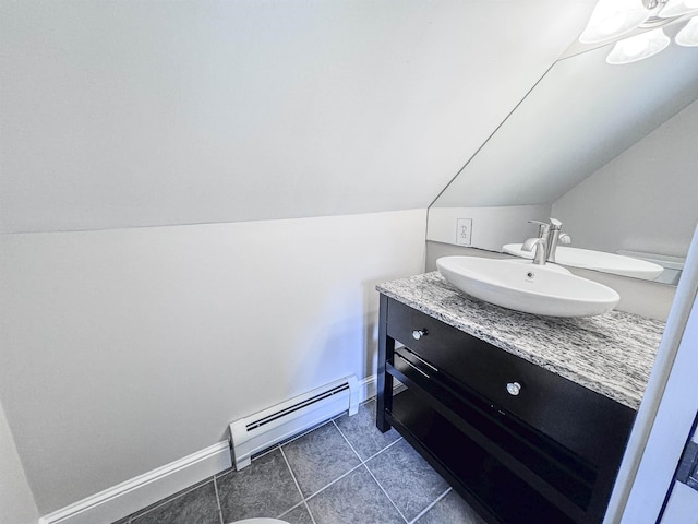 1043 Main St, Sunapee, NH 03751 - bathroom with a baseboard heating unit, lofted ceiling, vanity, and tile patterned flooring
