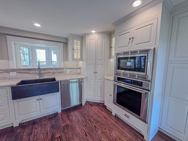 1043 Main St, Sunapee, NH 03751 - kitchen featuring appliances with stainless steel finishes, white cabinets, dark wood-type flooring, light stone counters, and recessed lighting
