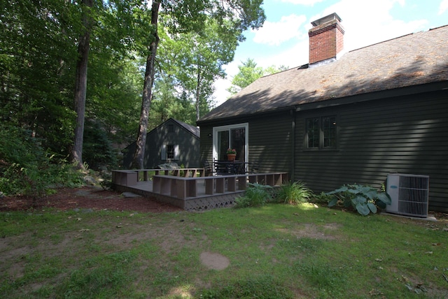 7 Minuteman Ln Unit 7, Exeter, NH 03833 - rear view of property with a deck, a chimney, a lawn, and roof with shingles