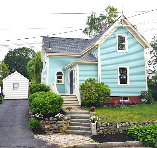 136 Sparhawk St, Portsmouth, NH 03801 - victorian-style house featuring roof with shingles, a chimney, and a front yard