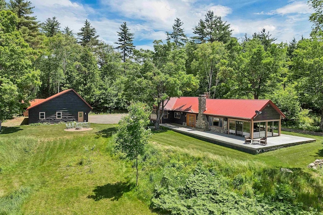83 Towle Rd, Jackson, NH 03846 - rear view of property with a yard, a metal roof, and a chimney