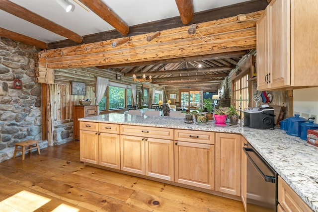 83 Towle Rd, Jackson, NH 03846 - kitchen with stainless steel dishwasher, light wood-style floors, beamed ceiling, a peninsula, and light brown cabinets