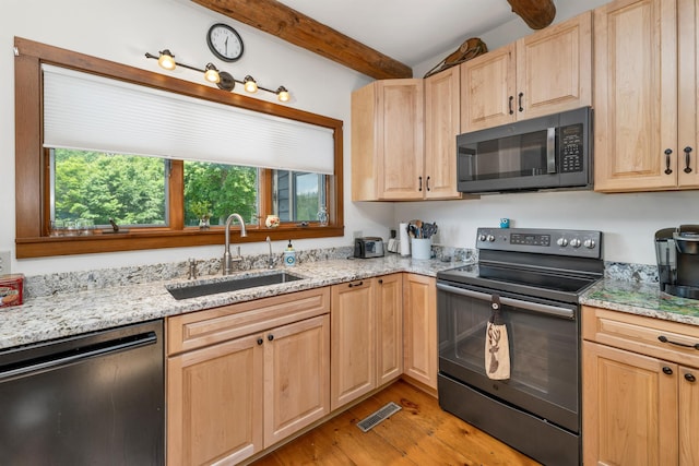 83 Towle Rd, Jackson, NH 03846 - kitchen featuring dishwashing machine, black range with electric cooktop, light brown cabinetry, beam ceiling, and light wood-style flooring