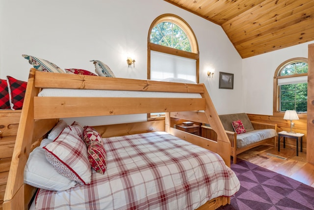 83 Towle Rd, Jackson, NH 03846 - bedroom with multiple windows, wood finished floors, wooden ceiling, a wainscoted wall, and high vaulted ceiling