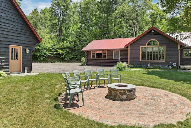 83 Towle Rd, Jackson, NH 03846 - rear view of house with an outdoor fire pit, a yard, a patio, and a metal roof