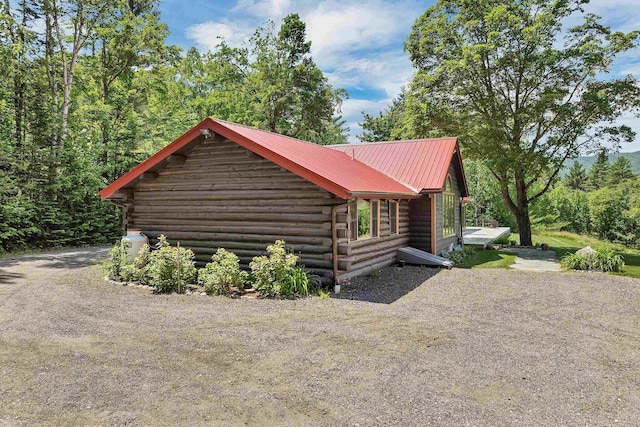 83 Towle Rd, Jackson, NH 03846 - view of home's exterior with log exterior, a metal roof, and driveway