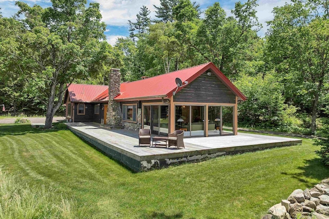 83 Towle Rd, Jackson, NH 03846 - rear view of property featuring a wooden deck, a chimney, a lawn, and a metal roof