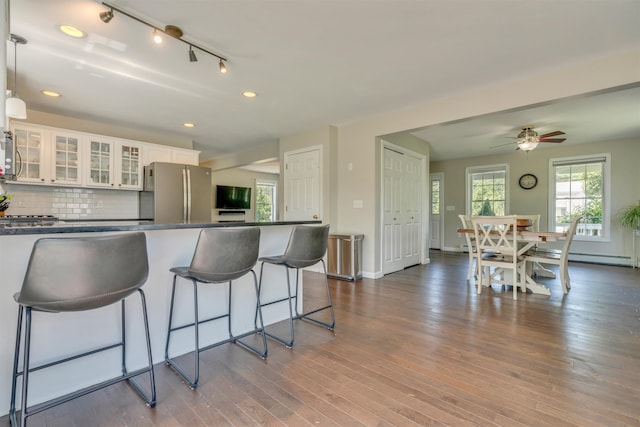 15 Winslow Dr, Somersworth, NH 03878 - kitchen featuring stainless steel appliances, dark countertops, a kitchen breakfast bar, white cabinetry, and wood finished floors
