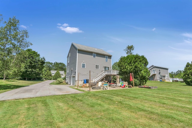 15 Winslow Dr, Somersworth, NH 03878 - back of property with stairs, an attached garage, a lawn, and concrete driveway