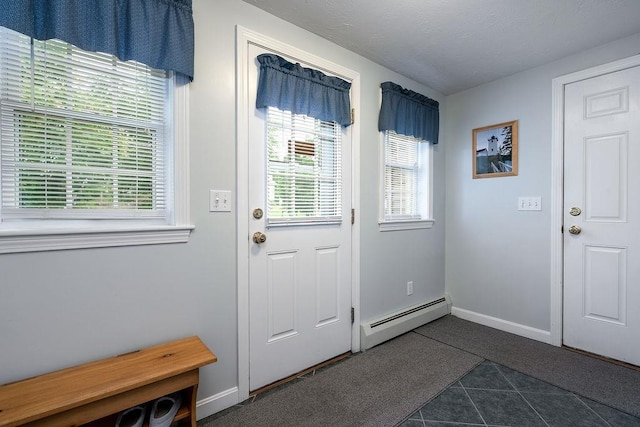 6 Lacy Ln, Nashua, NH 03062 - doorway to outside featuring baseboard heating and dark tile patterned floors