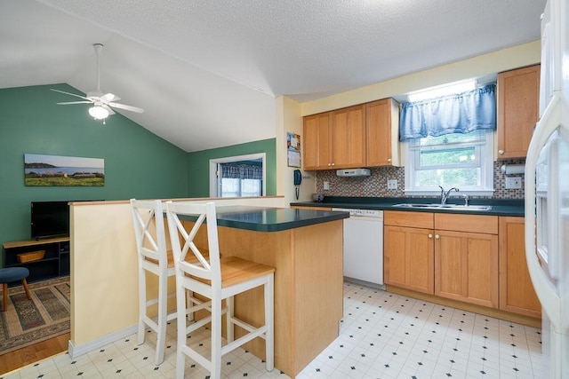 6 Lacy Ln, Nashua, NH 03062 - kitchen with dark countertops, dishwasher, lofted ceiling, backsplash, and a breakfast bar