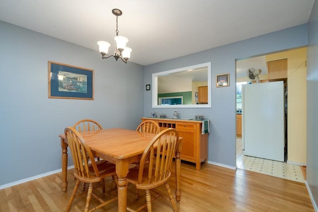 6 Lacy Ln, Nashua, NH 03062 - dining space with a chandelier and light wood-style floors