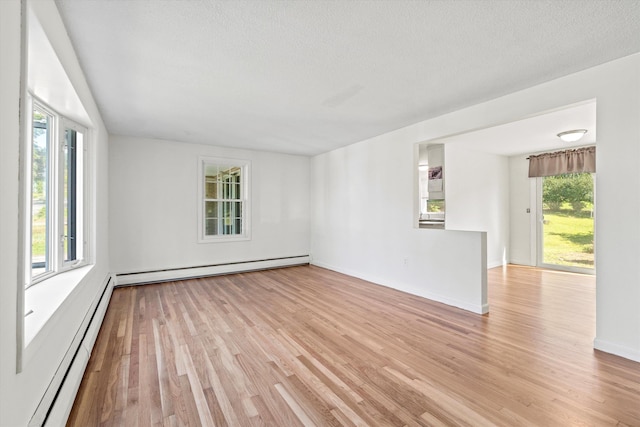 9 Bryant Rd, Nashua, NH 03062 - spare room with a baseboard radiator, a baseboard heating unit, light wood-type flooring, and a textured ceiling