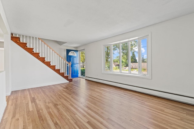 9 Bryant Rd, Nashua, NH 03062 - foyer featuring a baseboard radiator, stairs, and wood finished floors