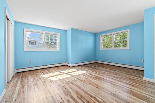 9 Bryant Rd, Nashua, NH 03062 - unfurnished bedroom with hardwood / wood-style flooring, a baseboard radiator, and a closet