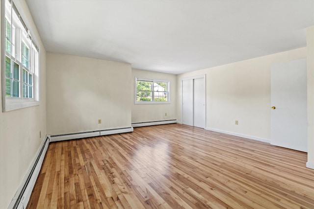9 Bryant Rd, Nashua, NH 03062 - unfurnished room featuring a baseboard heating unit and light wood-style floors