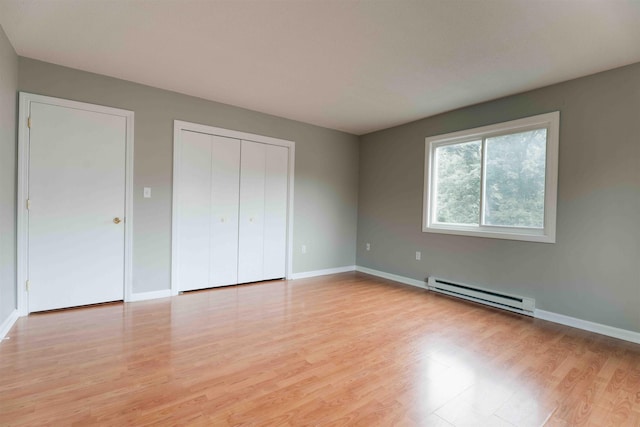 120 Fisherville Rd Unit 29, Concord, NH 03303 - unfurnished bedroom with a baseboard heating unit, light wood-style floors, and a closet
