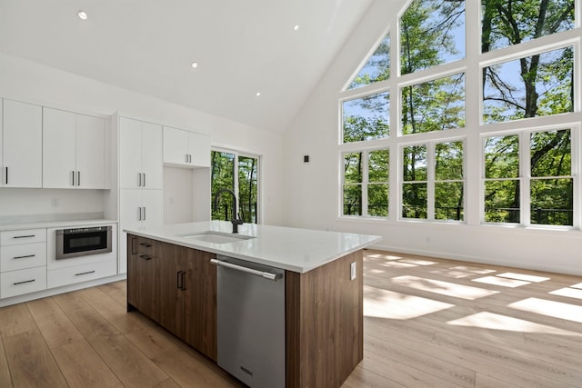 74 Scenic View Rd, Ashland, NH 03217 - kitchen featuring appliances with stainless steel finishes, high vaulted ceiling, light wood-type flooring, modern cabinets, and white cabinets