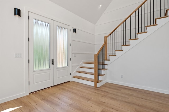 74 Scenic View Rd, Ashland, NH 03217 - entryway with stairway, light wood finished floors, french doors, lofted ceiling, and recessed lighting