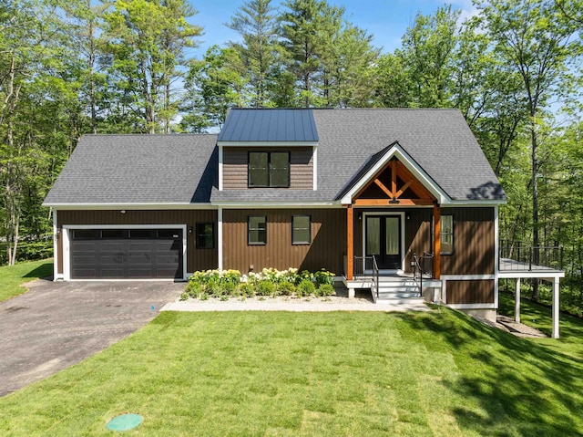 74 Scenic View Rd, Ashland, NH 03217 - view of front of home with asphalt driveway, an attached garage, french doors, a front lawn, and roof with shingles