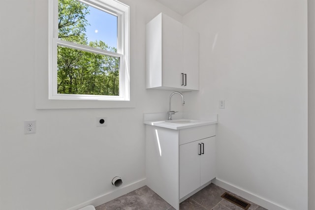 74 Scenic View Rd, Ashland, NH 03217 - laundry area featuring hookup for an electric dryer and cabinet space