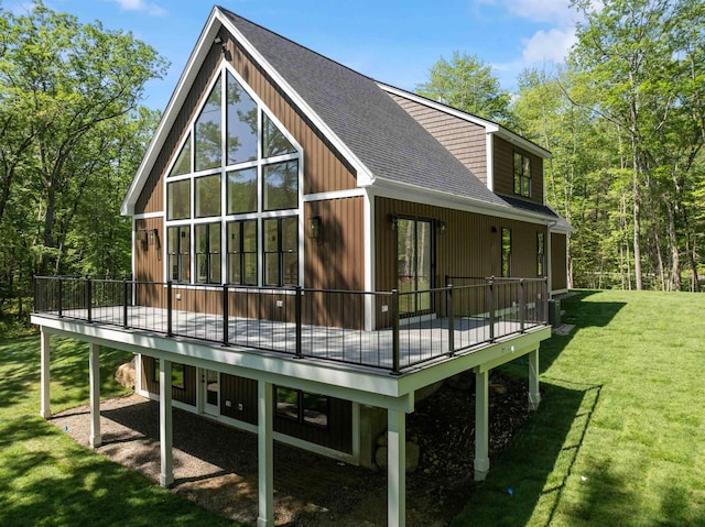 74 Scenic View Rd, Ashland, NH 03217 - rear view of house with a shingled roof, a deck, and a lawn