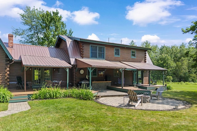 43 Knights Pond Rd, South Berwick, ME 03908 - rear view of property featuring log exterior, an outdoor fire pit, a patio area, a wooden deck, and a metal roof