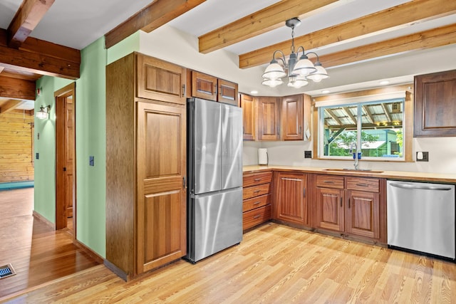 43 Knights Pond Rd, South Berwick, ME 03908 - kitchen featuring stainless steel appliances, beam ceiling, light wood-style floors, a chandelier, and light countertops