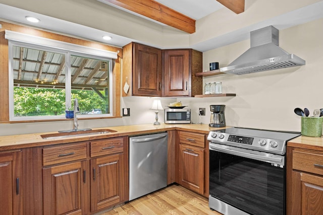 43 Knights Pond Rd, South Berwick, ME 03908 - kitchen featuring wall chimney exhaust hood, appliances with stainless steel finishes, beamed ceiling, light wood finished floors, and brown cabinets